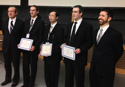 three award winner and two officials holding their award certificates